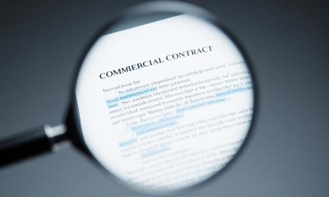 Close up of a legal document with a magnifying glass